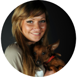 Smiling Woman Hugging a Dog Against Black Background