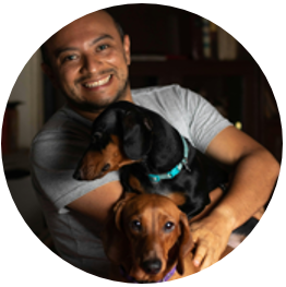 Smiling Man Posing with Dogs